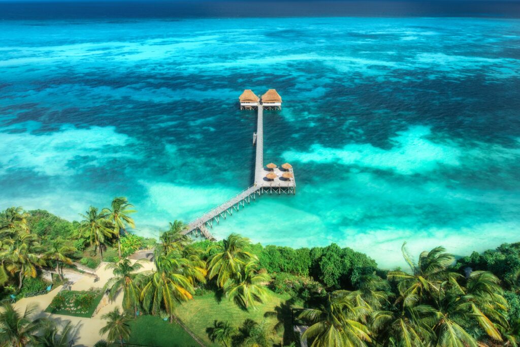 aerial,view,of,bungalow,,jetty,,white,sandy,beach,,ocean,on